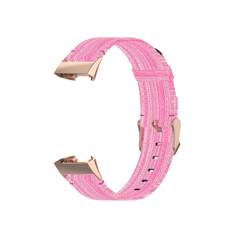 Pink nylon watch strap with rose-gold tone metal connector ends, angle view