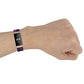 Purple nylon Fitbit watch strap worn on wrist, metal clasp visible on side