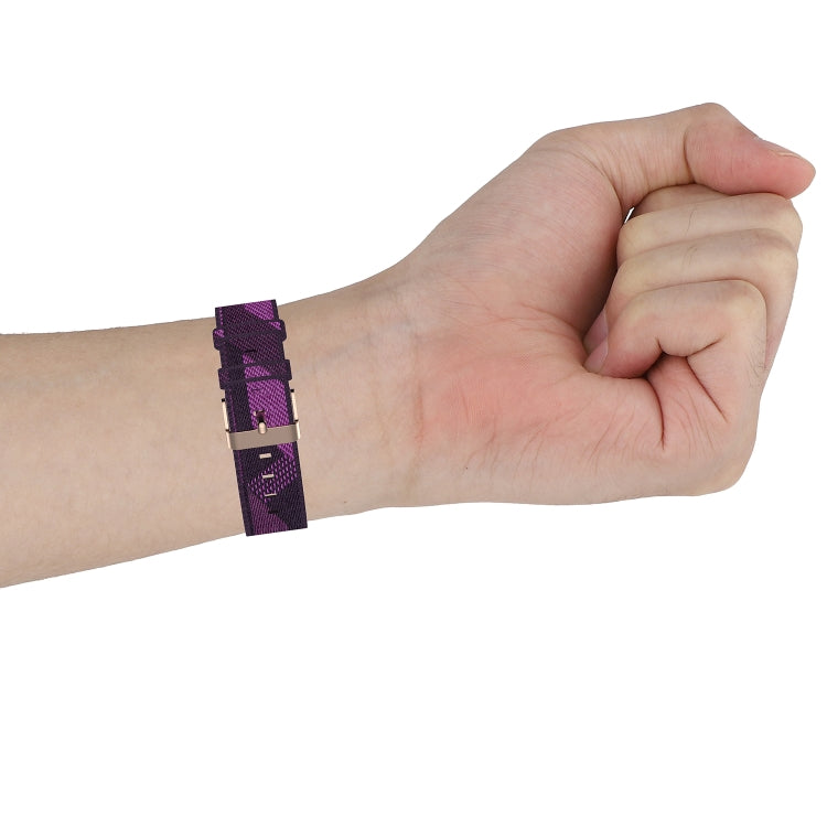 Purple nylon watch strap worn on wrist, adjustable band with metal clasp