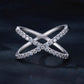 Silver crossover moissanite ring with pavé stones