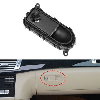 Black glove box handle switch panel with oval button opening and mounting tabs