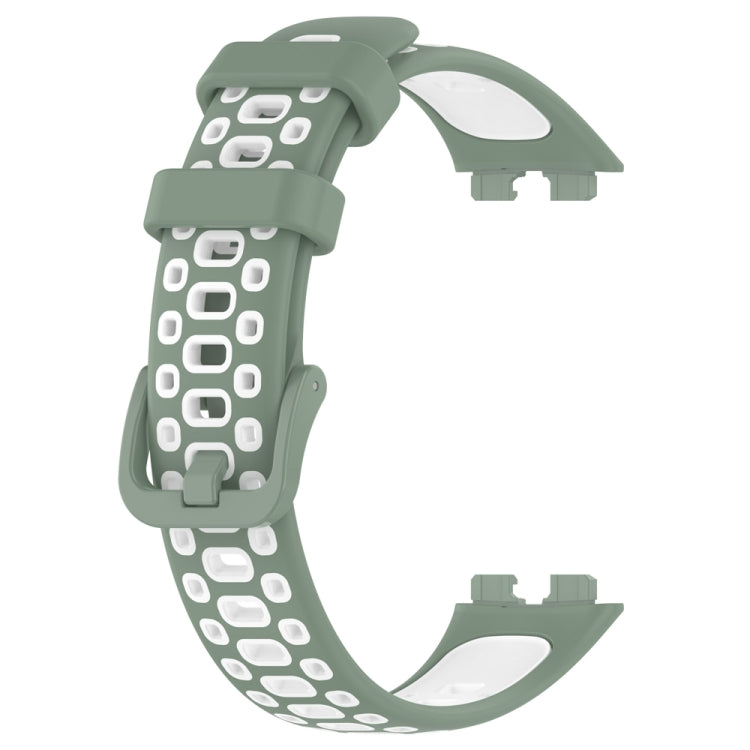 Two-tone silicone watch band, dark green outer with white patterned perforations.