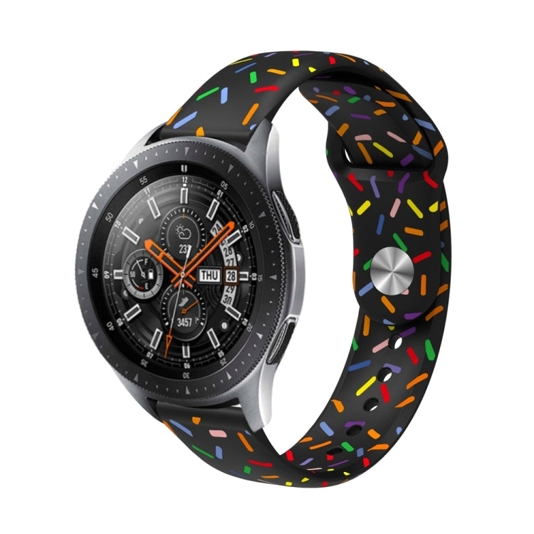 Black silicone watch band with colorful oval dot sprinkles pattern and reverse buckle.