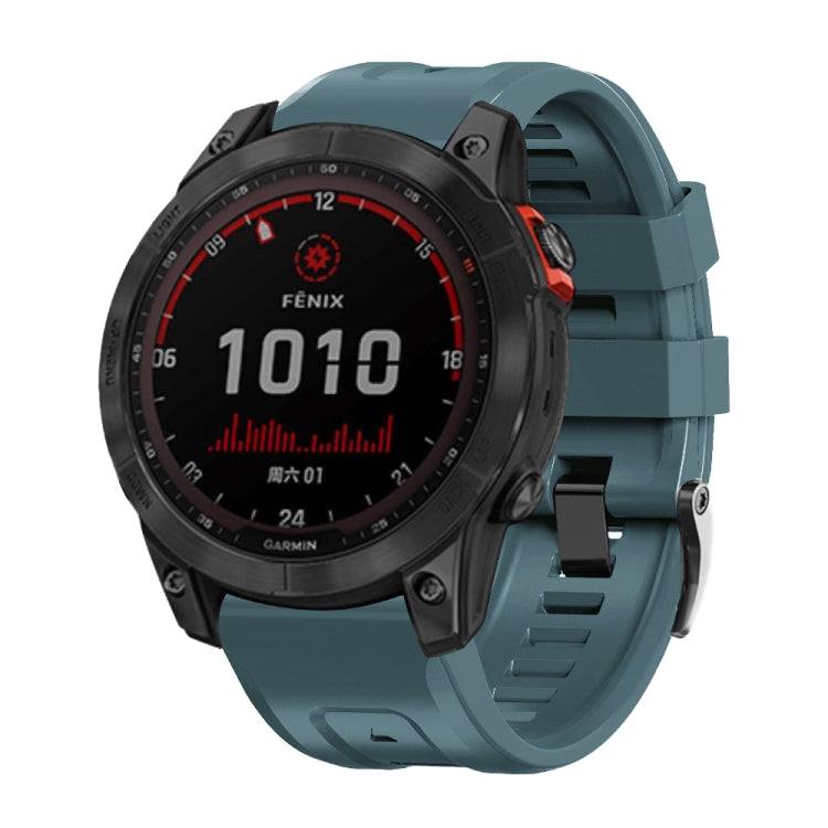 Teal silicone smartwatch band with metal buckle, front view on sport watch