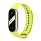Green silicone smartwatch band with black fitness tracker face and vented strap holes