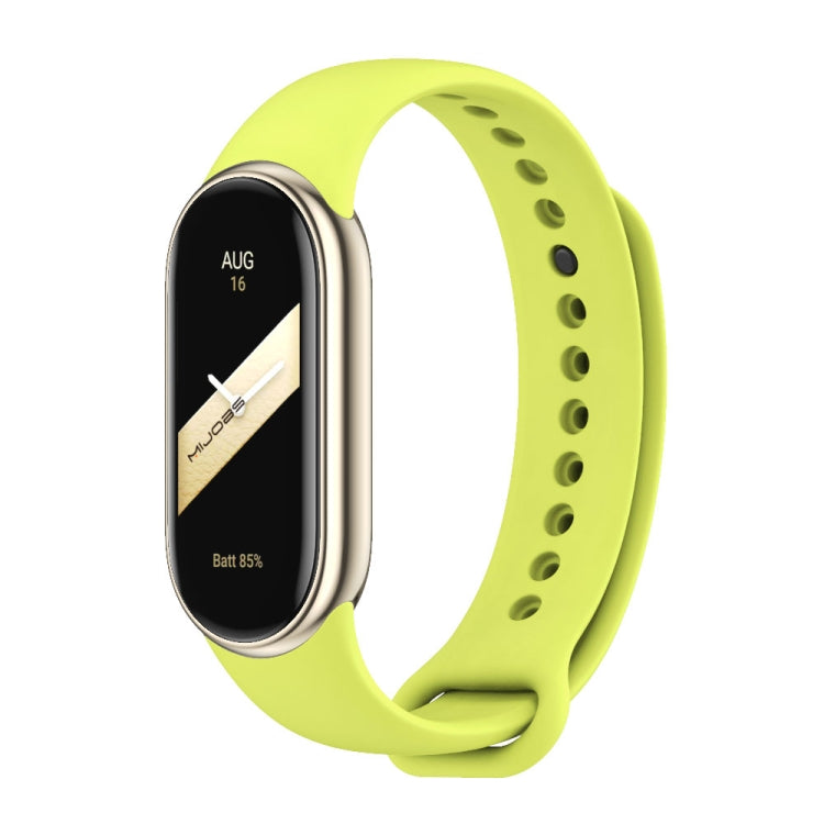 Green silicone smartwatch band with black fitness tracker face and vented strap holes
