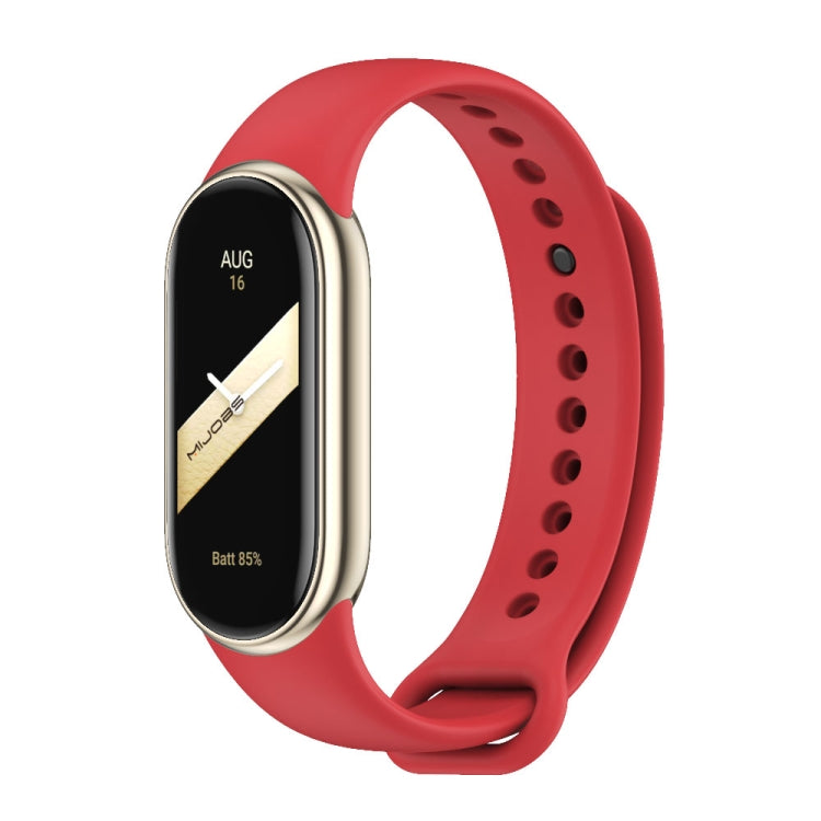 Red silicone smartwatch band with black fitness tracker face and vented strap holes