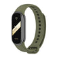 Olive green silicone smartwatch band with black fitness tracker face and vented strap holes