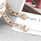 Rose gold watch band with sparkling rhinestone cross links, accessory close-up