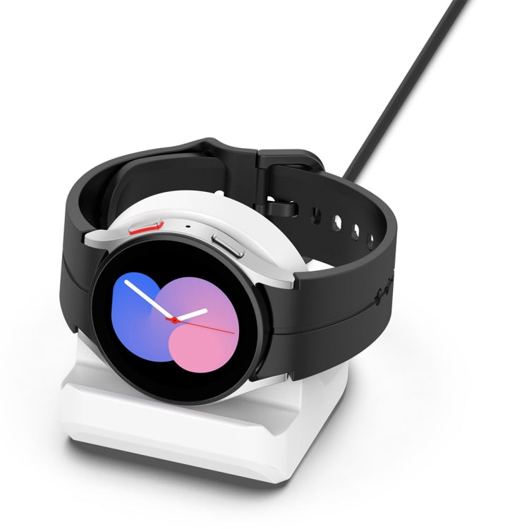 White-and-black silicone charging bracket holding a smartwatch in place