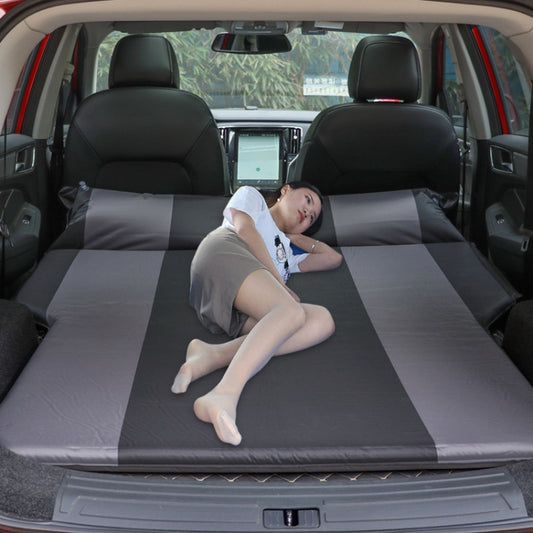 Inflatable car sleeping mat in SUV trunk, gray panels with person lounging inside