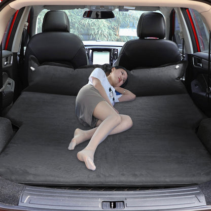 Black inflatable car sleeping mat mattress in SUV cargo area, person reclining inside