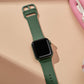Silicone watch band with pin buckle end in dark green, holes for sizing