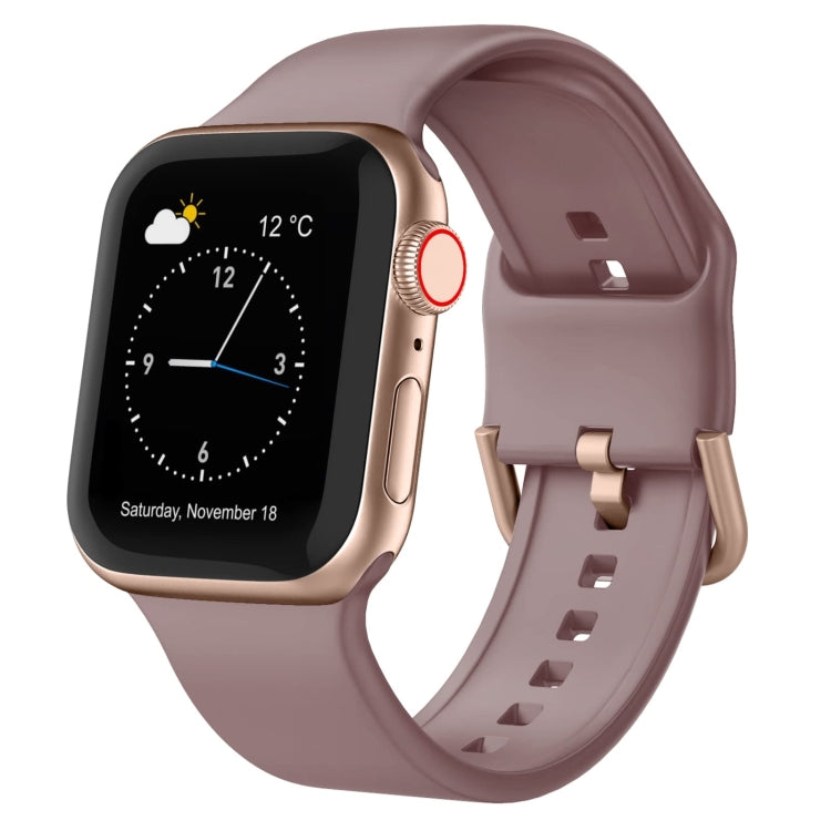 Dusty rose silicone Apple Watch pin buckle band with perforated strap and clasp.