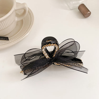 Black mesh bowknot hair gripper with rhinestones and gold-tone chain detail