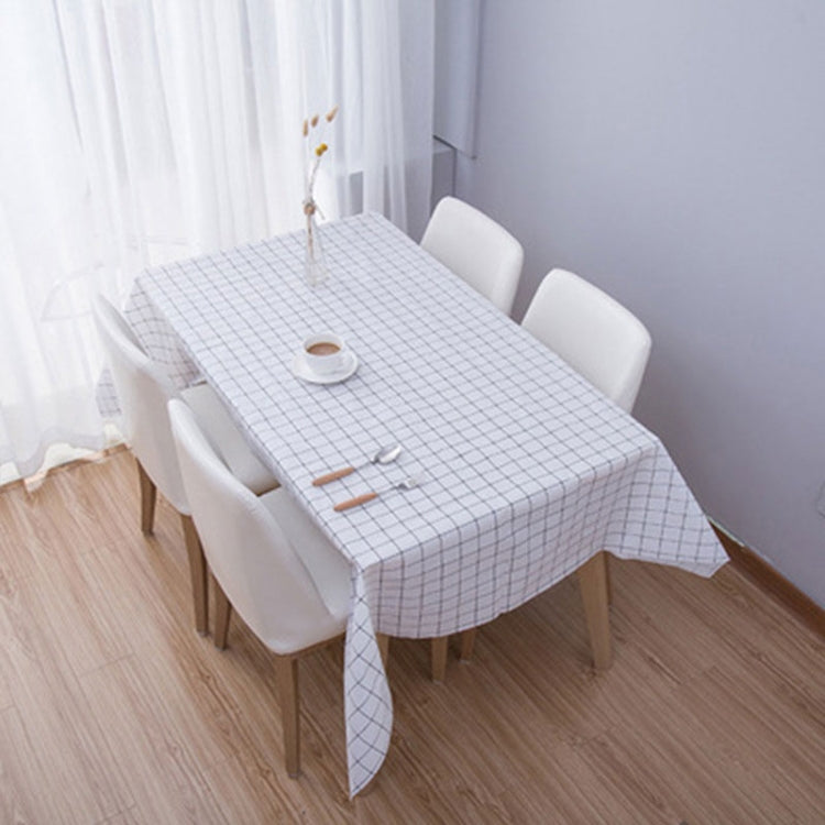 Grey plaid PVC coffee tablecloth with grid pattern, draped over a dining table