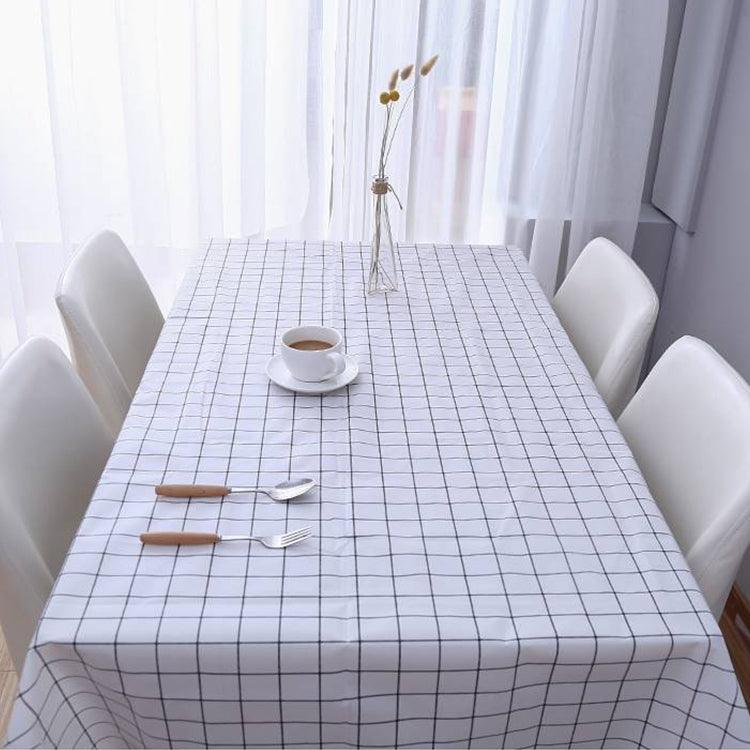 Grey plaid PVC tablecloth with grid design covering a dining table