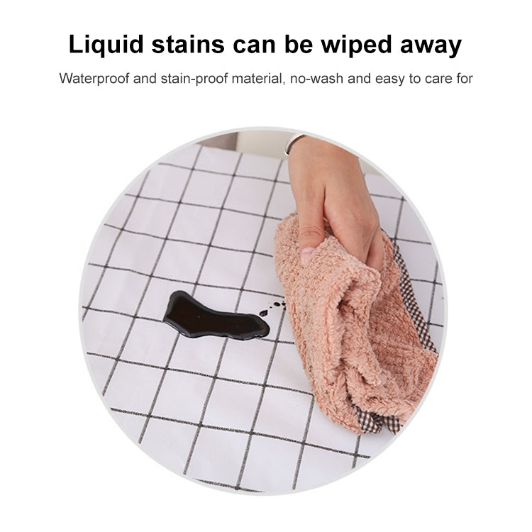Grey plaid PVC tablecloth surface being wiped clean with a cloth