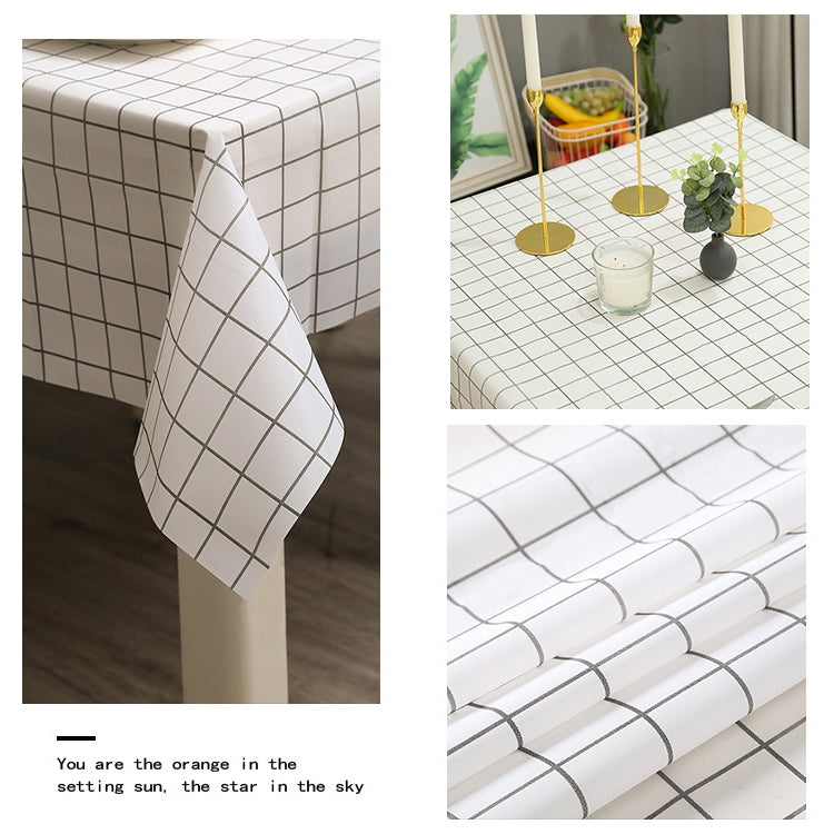 White plaid PVC tablecloth with dark grid, draped over table edge