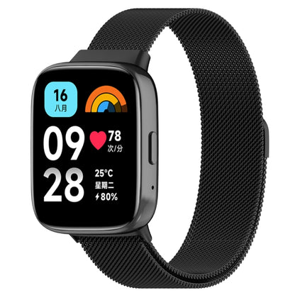 Black metal mesh watch band with clasp, paired with a smartwatch