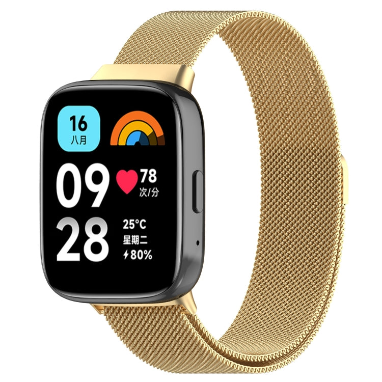 Gold metal mesh watch band with clasp, paired with a smartwatch