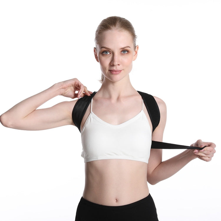Black posture correction belt with shoulder strap, fastened with a front adjustment strap