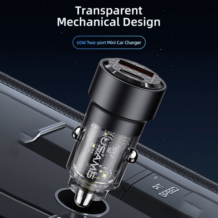 Black transparent dual-port car charger with metal ring and visible internal circuit.
