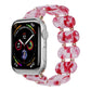Stretch resin watch band with red translucent links and rose-gold tone connectors