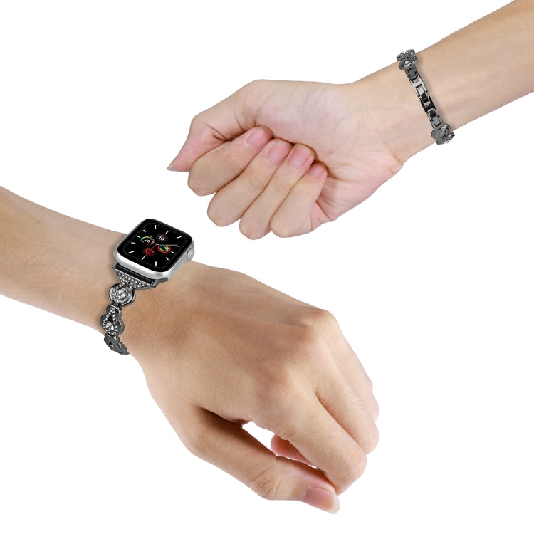 Black metal Apple Watch band with crystal gourd links worn on wrist