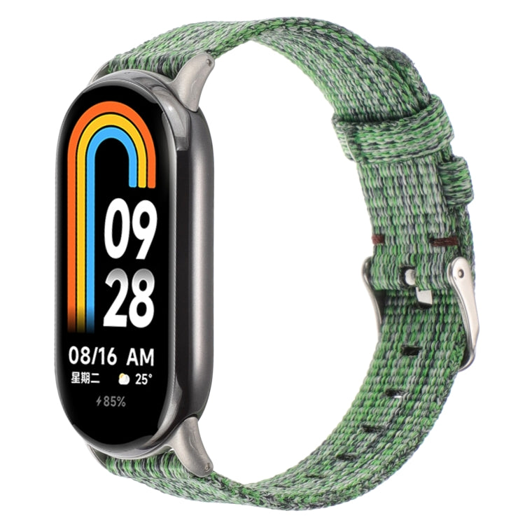 Green striped nylon canvas watch band with metal buckle and adjustable strap holes