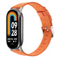 Orange nylon canvas watch band with metal clasp and pin buckle for a fitness tracker.