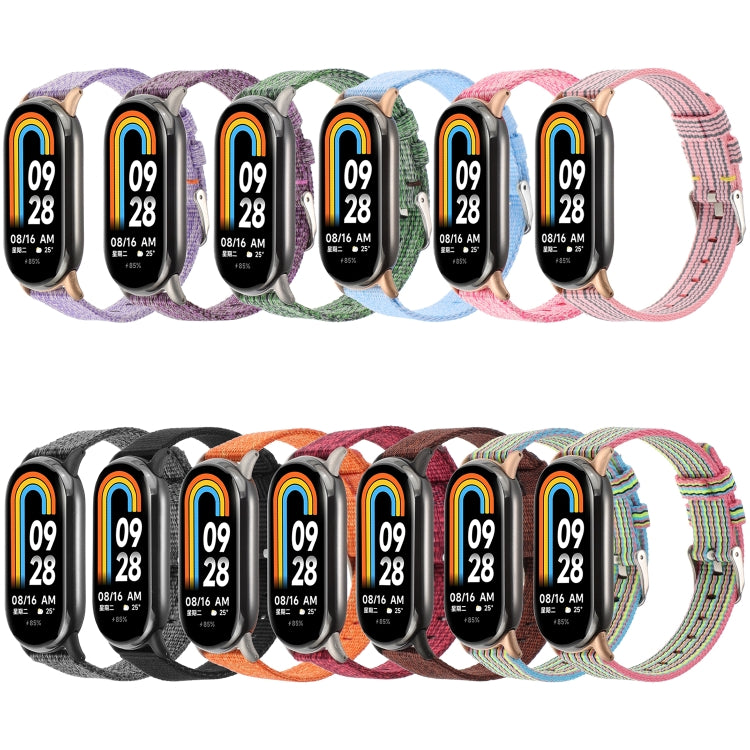 Assorted nylon canvas watch bands in multiple striped colors, each with metal clasp hardware.