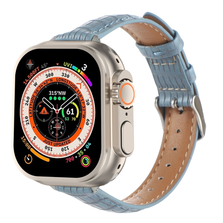 Light blue crocodile leather watch band with stitched edges and buckle holes