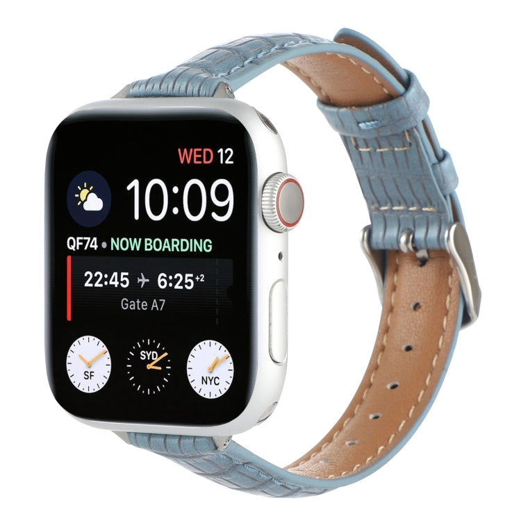Slim crocodile leather watch band in light blue, with stitched holes and buckle strap