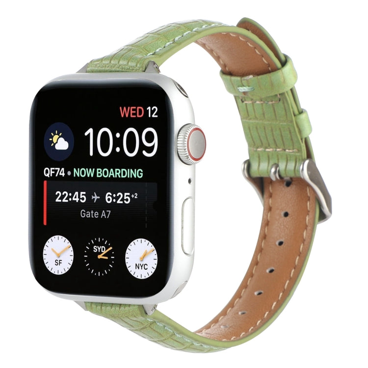 Slim crocodile leather watch band in light green, with stitched holes and buckle strap