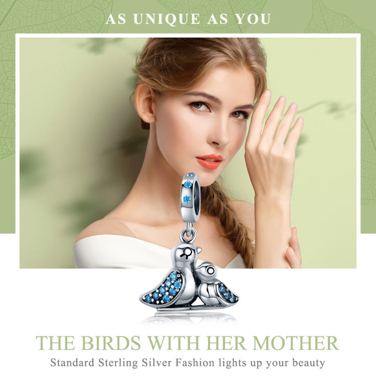 Sterling silver bird bracelet with blue inlaid gems and mother-and-chick bird charm