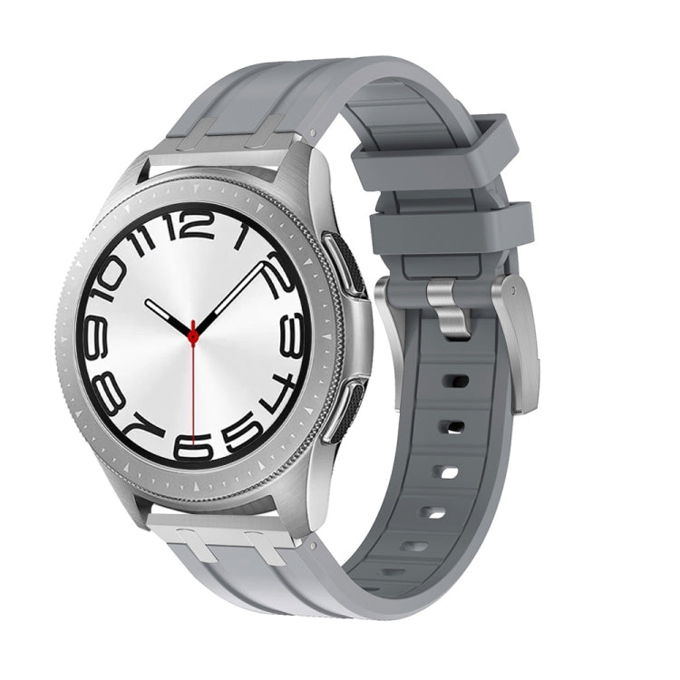 Smartwatch with a gray silicone band, silver case, and white dial