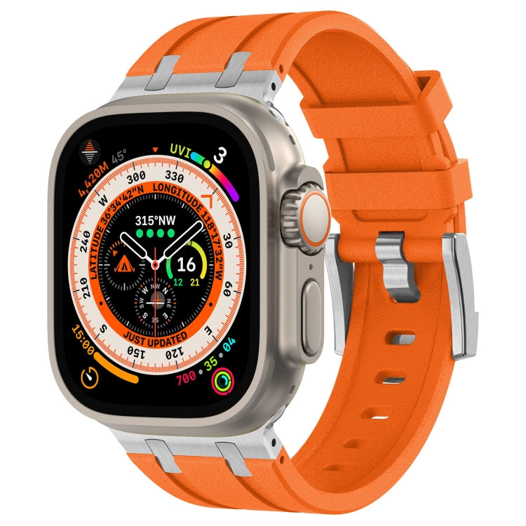 Apple Watch fitted with an orange silicone band and metal connectors