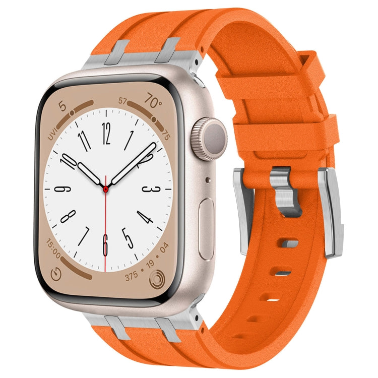 Orange silicone Apple Watch band with silver connectors, shown fitted to a watch