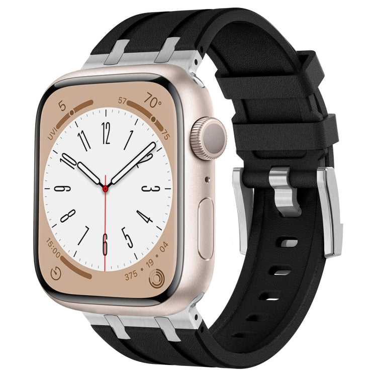Black silicone Apple Watch band with silver connectors, shown fitted to a watch