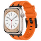 Orange silicone Apple Watch band with black connectors, shown fitted to a watch