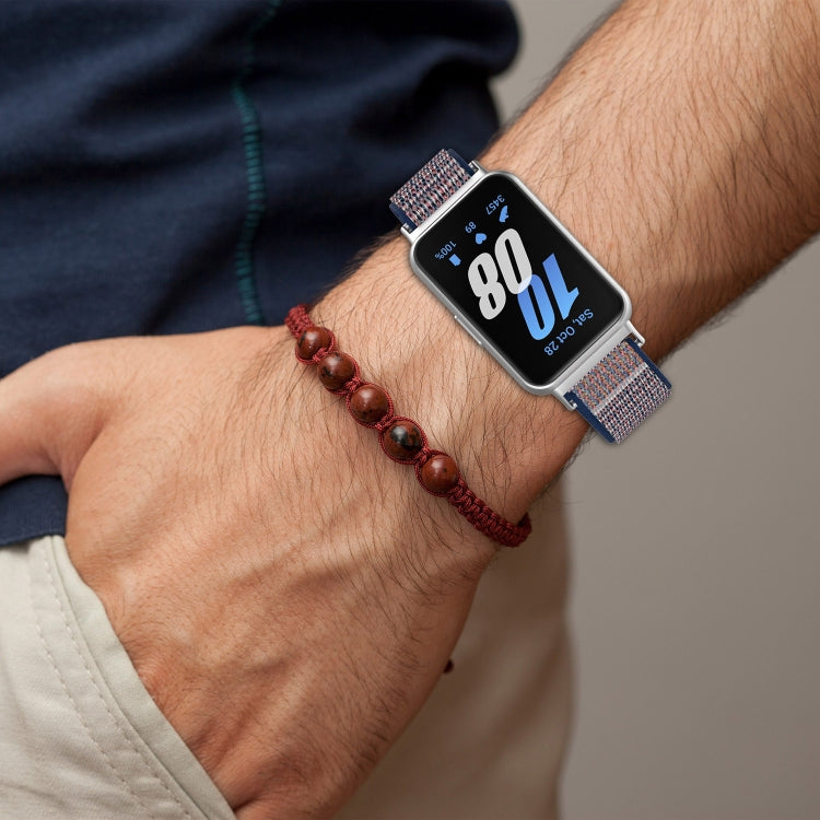 Blue and gray nylon watch band with hook-and-loop closure, worn on wrist