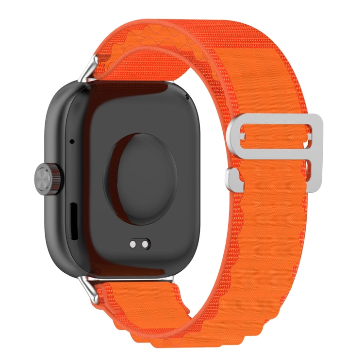 Orange nylon loop watch band attached to a smartwatch, showing the back and metal buckle.