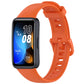 Orange silicone watch band with buckle, shown on a Huawei fitness tracker