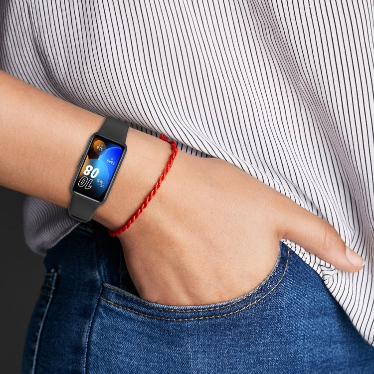 Black silicone watch band worn on a wrist