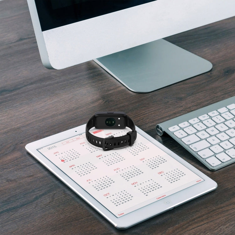 Black silicone watch band wrapped around a fitness tracker