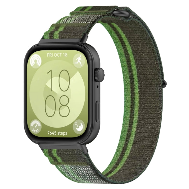 Loop nylon watch band in dark green with bright green stripes, shown on a black watch