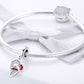 Silver charm bracelet with heart-to-heart pendant, red enamel, and clip clasp