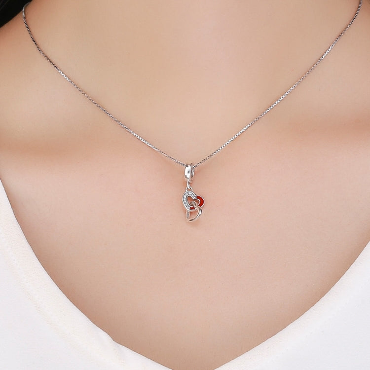 Silver necklace pendant with heart-to-heart charm, red enamel, and small linked heart detail
