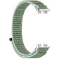 Green nylon hook-and-loop watch band with metal connectors, shown unattached